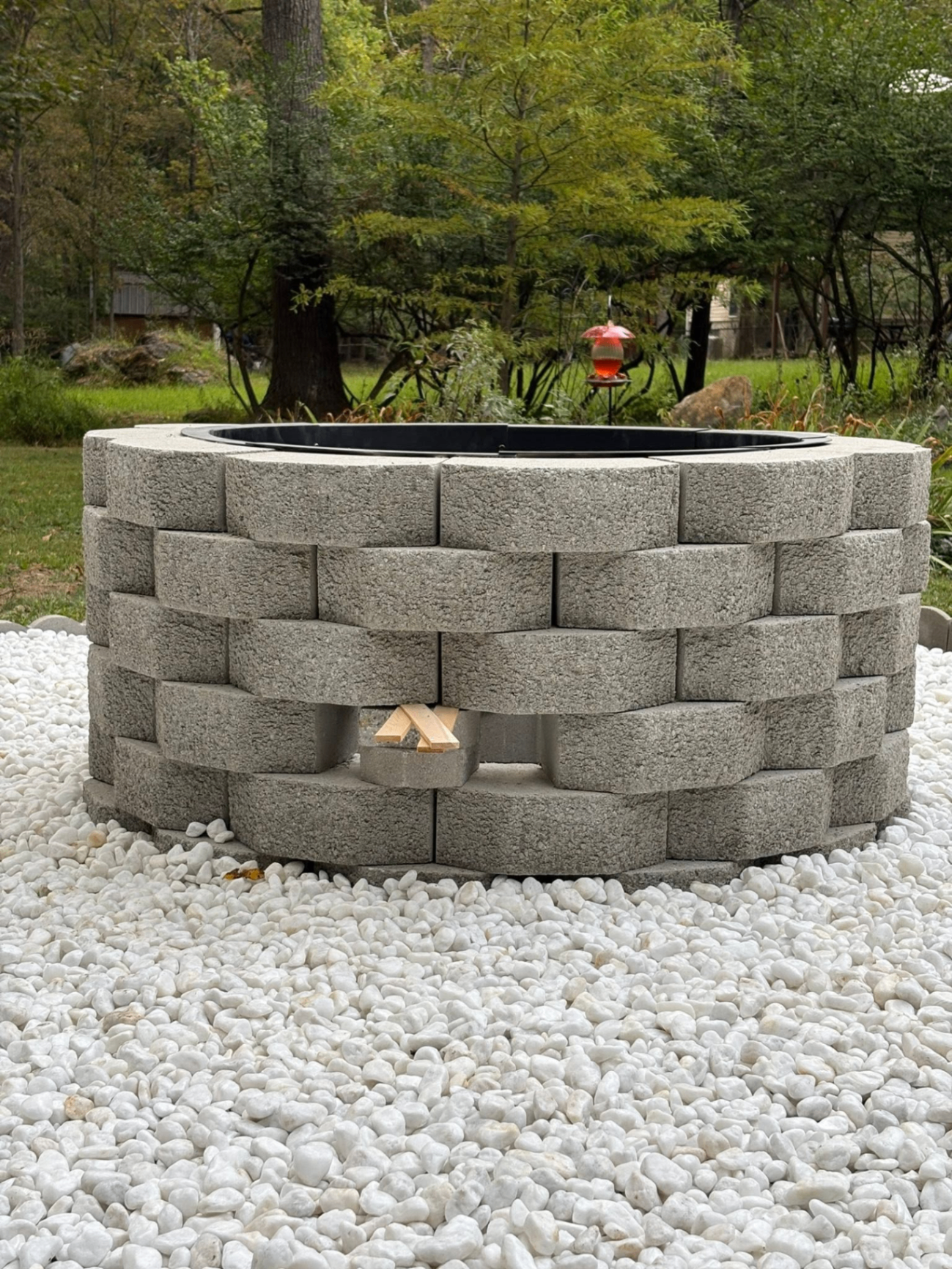 Custom circular stone fire pit installed outdoors